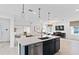 Modern kitchen island with quartz countertop and stainless steel appliances at 3446 Orange Rose Loop, Apopka, FL 32712