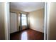 Charming bedroom with wood floors and a window with curtains at 3700 Idlebrook Cir # 208, Casselberry, FL 32707