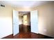Well-lit bedroom with wood floors and access to living area at 3700 Idlebrook Cir # 208, Casselberry, FL 32707