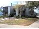 Two-story condo building with gray and blue siding, walkway, and landscaping at 3700 Idlebrook Cir # 208, Casselberry, FL 32707