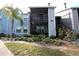 Condo building exterior with screened balcony and landscaping at 3700 Idlebrook Cir # 208, Casselberry, FL 32707