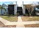 Two-story condo building with gray and blue siding, walkway, and landscaping at 3700 Idlebrook Cir # 208, Casselberry, FL 32707