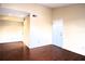 Spacious living room featuring wood flooring and an exterior door at 3700 Idlebrook Cir # 208, Casselberry, FL 32707