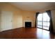 Living room with hardwood floors, fireplace, and access to balcony at 3700 Idlebrook Cir # 208, Casselberry, FL 32707
