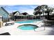 Community pool and spa with lounge chairs and tables at 3700 Idlebrook Cir # 208, Casselberry, FL 32707