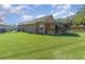 Large backyard with covered patio and spacious grassy area at 5210 Sailwind Cir, Orlando, FL 32810