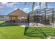 Backyard oasis with covered patio, outdoor kitchen, and fire pit at 5210 Sailwind Cir, Orlando, FL 32810