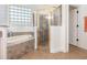 Clean bathroom with a shower, bathtub, and granite countertop at 5210 Sailwind Cir, Orlando, FL 32810