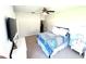 Comfortable bedroom with ceiling fan, neutral carpeting, and stylish furnishings at 5210 Sailwind Cir, Orlando, FL 32810