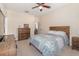 Well-lit bedroom with a dresser and a queen-size bed at 5210 Sailwind Cir, Orlando, FL 32810