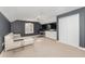 Versatile bonus room with a sectional sofa and home office area at 5210 Sailwind Cir, Orlando, FL 32810