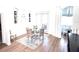 Bright dining area with modern chandelier, elegant furnishings, and wood flooring at 5210 Sailwind Cir, Orlando, FL 32810