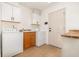 Bright laundry room with washer, dryer, and upper cabinets at 5210 Sailwind Cir, Orlando, FL 32810