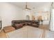 Spacious living room featuring a large sectional sofa and a view into the kitchen at 5210 Sailwind Cir, Orlando, FL 32810