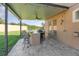 Outdoor kitchen and covered patio with seating area at 5210 Sailwind Cir, Orlando, FL 32810
