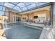 Relaxing pool and patio area with a covered lanai and large TV at 5210 Sailwind Cir, Orlando, FL 32810