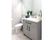 Modern bathroom with gray vanity, white countertop, and stylish fixtures at 526 First Cape Coral Dr, Winter Garden, FL 34787