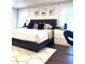Main bedroom with king bed, geometric rug, and stylish decor at 526 First Cape Coral Dr, Winter Garden, FL 34787