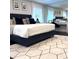 Spacious bedroom with king-size bed, geometric rug, and window treatments at 526 First Cape Coral Dr, Winter Garden, FL 34787