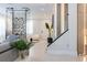 Modern entryway with glass wine cellar and staircase at 526 First Cape Coral Dr, Winter Garden, FL 34787