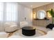 Modern entryway with contemporary seating and a statement mirror at 526 First Cape Coral Dr, Winter Garden, FL 34787
