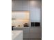 Modern kitchen with gray cabinets and stainless steel appliances at 526 First Cape Coral Dr, Winter Garden, FL 34787