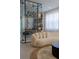 Elegant living room boasts a curved cream sofa and a stylish modern wine cellar at 526 First Cape Coral Dr, Winter Garden, FL 34787