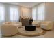 Modern living room with a curved sofa, circular rug, and unique coffee table at 526 First Cape Coral Dr, Winter Garden, FL 34787