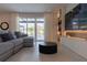 Relaxing living area with sectional sofa and large TV at 526 First Cape Coral Dr, Winter Garden, FL 34787