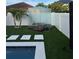 Relaxing outdoor area with glass enclosure, artificial turf, and patio stones at 526 First Cape Coral Dr, Winter Garden, FL 34787
