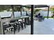 Outdoor kitchen with granite counters, stainless steel appliances, and bar seating at 526 First Cape Coral Dr, Winter Garden, FL 34787