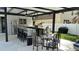 Outdoor kitchen with bar seating and dining area at 526 First Cape Coral Dr, Winter Garden, FL 34787