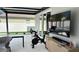 Covered patio with exercise bike and large TV at 526 First Cape Coral Dr, Winter Garden, FL 34787