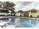 Stunning pool and spa with pergola, landscaping, and outdoor furniture at 526 First Cape Coral Dr, Winter Garden, FL 34787