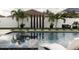 Relaxing pool area with a spa, water feature, and lush landscaping at 526 First Cape Coral Dr, Winter Garden, FL 34787