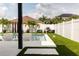 Modern pool and spa with artificial turf and outdoor seating at 526 First Cape Coral Dr, Winter Garden, FL 34787