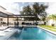 Resort-style pool with pergola, spa, and outdoor seating area at 526 First Cape Coral Dr, Winter Garden, FL 34787