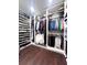Well-organized walk-in closet with hanging rods and shelves at 526 First Cape Coral Dr, Winter Garden, FL 34787