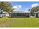 Wide view of backyard showing the enclosed lanai and detached garage at 6121 Bass Hwy, St Cloud, FL 34771