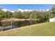 Scenic backyard view featuring a tranquil pond with a small dock and bench at 6121 Bass Hwy, St Cloud, FL 34771