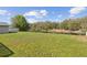Beautiful backyard with pond, surrounded by lush trees and green grass at 6121 Bass Hwy, St Cloud, FL 34771