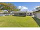 Well-maintained lawn shows the property's screened-in patio and the separate outbuilding at 6121 Bass Hwy, St Cloud, FL 34771