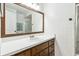 Bathroom vanity featuring wood cabinets and white countertops, complemented by a large mirror at 6121 Bass Hwy, St Cloud, FL 34771