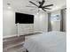 Bright bedroom is equipped with a ceiling fan, tv and dresser and has lots of natural light at 6121 Bass Hwy, St Cloud, FL 34771