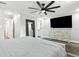 Well-lit bedroom features a mounted TV, and an en-suite bathroom for added privacy and comfort at 6121 Bass Hwy, St Cloud, FL 34771