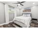 Cozy bedroom with a ceiling fan, a large picture window and soft, neutral decor at 6121 Bass Hwy, St Cloud, FL 34771