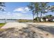 Public boat ramp providing lake access, featuring a concrete launch area, informational signs, and shaded by large trees at 6121 Bass Hwy, St Cloud, FL 34771