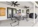 Inviting covered patio features dual ceiling fans and a dining area, perfect for outdoor entertaining at 6121 Bass Hwy, St Cloud, FL 34771