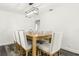 Elegant dining room with a wooden table and seating for eight, illuminated by a modern chandelier at 6121 Bass Hwy, St Cloud, FL 34771