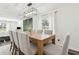 Open-concept dining area with a large table, seating, and connection to the living room at 6121 Bass Hwy, St Cloud, FL 34771